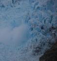 Mist escapes from the ice at the edge of a Greenland glacier.