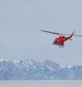 Researchers are deploying GPS units on glaciers in Greenland and Alaska to track the flow of ice out to sea. Team members from Ohio State University, NASA's Jet Propulsion Laboratory, and the University of Colorado-Boulder/NOAA Cooperative Institute for Research in Environmental Sciences reported their early results at the American Geophysical Union meeting in San Francisco. Here a helicopter carries members of a research team from base camp to a Greenland glacier.