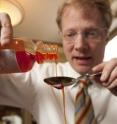 Research led by Dr. Brian Wansink, director of the Cornell Food and Brand Lab, shows we should not rely upon kitchen spoons when measuring liquid medicine.  Here, Dr. Wansink conducts a test pour in the lab's kitchen.