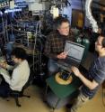 Georgia Tech researchers work in their laboratory with equipment used to study reaction rates of three key greenhouse gases.  Shown are Patrick Laine, J. Michael Nicovich, Paul Wine and Zhijun Zhao.