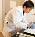 Bing Hu, a post-doctoral fellow in Yi Cui's research group at Stanford, prepares a small square of ordinary paper with an ink that will deposit nanotubes on the surface that can then be charged with energy to create a battery. Bing Hu, a post-doctoral fellow in Yi Cui's research group at Stanford, prepares a small square of ordinary paper with an ink that will deposit nanotubes on the surface that can then be charged with energy to create a battery.