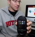 Rutgers computer science graduate student Jeffrey Bickford with smart phone used to test malicious "rootkit" software, which attacks the phone's operating system. Researchers showed how rootkits could cause a smart phone to eavesdrop on a meeting, track its owner's travels, or rapidly drain its battery to render the phone useless.