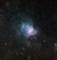 NGC 346 is the brightest star-forming region in the neighboring Small Magellanic Cloud galaxy, some 210,000 light-years away from Earth. The light, wind and heat given off by massive stars have dispersed the glowing gas within and around this star cluster, forming a surrounding wispy nebular structure that looks like a cobweb. NGC 346 is located in the constellation Tucana (the Toucan) and spans approximately 200 light-years. This particular image was obtained using the Wide Field Imager instrument at the 2.2-metre MPG/ESO telescope at the La Silla Observatory in Chile. Images like this help astronomers chronicle star birth and evolution, while offering glimpses of how stellar development influences the appearance of the cosmic environment over time. This is an enhanced color image based on three different broadband filters (B, V, R), as well as a narrowband filter (H-alpha, shown in blue). The field of view is about 30 arcminutes wide.