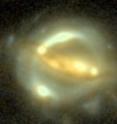 Oftentimes it is difficult for scientists to distinguish between a very bright light far away and a dimmer source lying much closer.  A gravitational lens circumvents this problem by providing multiple clues as to the distance light travels. When a large nearby object, such as a galaxy, blocks a distant object, such as another galaxy, the light can detour around the blockage. But instead of taking a single path, light can bend around the object in one of two, or four different routes, thus doubling or quadrupling the amount of information scientists receive. As the brightness of the background galaxy nucleus fluctuates, physicists can measure the ebb and flow of light from the four distinct paths, such as in the B1608+656 system imaged above.