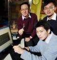 Georgia Tech Professor Zhong Lin Wang and researchers Chen Xu and Sheng Xu examine images of nanowire arrays used in their improved nanogenerator.