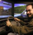 Jason Watson, a University of Utah psychologist, negotiates cybertraffic in a driving simulator used to study driver distractions such as cell phones and testing. While many people think they can safely drive and talk on a cell phone at the same time, Watson's new study shows only one in 40 is a "supertasker" who can perform both tasks at once without impairment of abilities measured in the study.