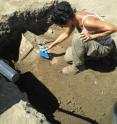 Gabii project field director Anna Gallone brushes dirt away from the lead-encased burial.