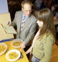 Professor Brian Wansink measures portion sizes with a student assisting with research for the Food and Brand Lab.
