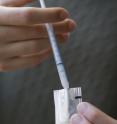 This is a close-up of a HIV medication pouch being filled.