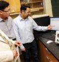 From left, Arvind Varma, Purdue University's R. Games Slayter Distinguished Professor of Chemical Engineering, postdoctoral researcher Hyun Tae Hwang and doctoral student Ahmad Al-Kukhun review data from a new process for storing and generating hydrogen to run fuel cells in cars and portable consumer electronics. The process, called hydrothermolysis, uses a powdered material called ammonia borane, which contains one of the highest hydrogen contents of all solid materials.
