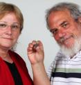 Dr. Eilat Mazar (left) and Prof. Wayne Horowitz of the Hebrew University Institute of Archaeology pose with the 14th century B.C.E. clay tablet fragment found in Jerusalem.