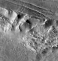 An outtake from the Mars mosaic captures a 90-mile-wide portion of the giant Valles Marineris canyon system. The image shows landslide debris and gullies in the canyon walls at 100 meters (330 feet) per pixel.