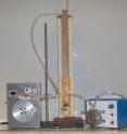 This image shows a smoking machine.  From left to right: a puffer box, a manometer, and a pump.