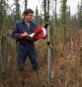 University of Alaska Fairbanks Professor Vladimir Romanovsky measures permafrost temperature at a borehole in interior Alaska.