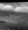 The mare basalts that fill the Taurus-Littrow valley were thrust up by contractional forces to form the Lee-Lincoln fault scarp, just west of the Apollo 17 landing site (arrow). It is the only extraterrestrial fault scarp to be explored by humans (astronauts Eugene Cernan and Harrison Schmitt).  The digital terrain model derived from Lunar Reconnaissance Orbiter Camera (LROC) stereo images shows the fault extending upslope into North Massif were highlands material are also thrust up. The fault cuts upslope and abruptly changes orientation and cuts along slope, forming a narrow bench.  LROC images show boulders shed from North Massif that have rolled downhill and collected on the bench.