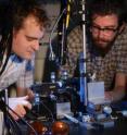 Research physicists Jonathan Matthews (left) and Kostas Poulios 
aligning the quantum optical chip. The photons are injected into the chip 
using optical fiber and requires precision alignment.
