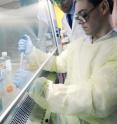 Postdoctoral fellow Kenneth Scarberry uses bioconjugate techniques to bind ligands to silicon nanowires, while graduate research assistant Ramasamy Ravindran observes.