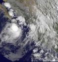 The GOES-11 satellite captured an infrared image of Tropical Storm Georgette's (left) clouds reaching into Baja California, Mexico at 13:15 UTC 9:15 a.m. EDT on Sept. 21.