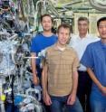 Hendrik Bluhm, Michael Grass, Zahid Hussain and Zhi Liu stand with the APXPS detection system at beamline 11.0.2.