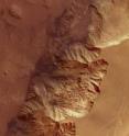 To the left of the image is Melas Chasma, a part of the huge Valles Marineris rift valley, which stretches for more than 4.000 km across the face of Mars. Melas Chasma itself sinks 9 km below the surrounding plains, on the right of the image, making it one of the lowest depressions on Mars. This image covers 200 x 100 km and covers an area of roughly 20.000 sq km, which is about the size of Slovenia.