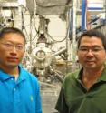 Wei Han (left) is a graduate student working in the lab of Roland Kawakami (right), an associate professor of physics and astronomy at   	 University of California -- Riverside. The machine in the back is the molecular beam epitaxy chamber, where the researchers grew the titanium and the tunnel barriers.