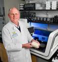 Dr. Elder uses a robot to help pipette DNA samples in his lab.
