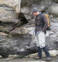 Geologist Noah Plavansky examines rocks deposited after a "Snowball Earth" glacial event.