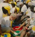 Charles Mackenzie, a professor of veterinary pathology, works with elephantiasis patients in Tanzania.
