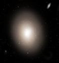 The biggest galaxies in the universe are elliptical galaxies like the one in this artist's conception. The largest of these hold over one trillion stars according to astronomical census takers, compared to 400 billion in our Milky Way. However, new research shows that elliptical galaxies actually hold five to ten times as many stars as previously believed.