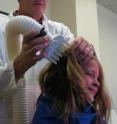 University of Utah biology Professor Dale Clayton demonstrates how the LouseBuster is used to kill head lice and their eggs by blowing a large volume of warm air onto the hair and scalp. A new study found that lice are effectively eradicated by the commercial version of the device, which has gained clearance from the US Food and Drug Administration and now is being sold by university spinoff company Larada Sciences of Salt Lake City for use in schools, camps, medical clinics and delousing businesses.