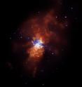 M82 is a galaxy where stars are forming at rates that are tens or even hundreds of times higher than in a normal galaxy.  In this Chandra image (where low, medium, and high-energy X-rays are colored red, green and blue respectively), M82 is seen nearly edge-on with its disk crossing from about 10 o'clock to about 4 o'clock.  There are over a hundred point-like X-ray sources, some of which are likely black holes pulling matter from companion stars.  Supernovas have produced the large bubbles of hot gas that extend for millions of light years to the upper right and lower left of the galactic disk.