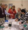 Researchers prepare a sample of hydrated nanocrystals used in a December 2009 experiment at the Linac Coherent Light Source located at the Department of Energy’s SLAC National Accelerator Laboratory. From left, John C.H. Spence, Uwe Weierstall and Petra Fromme from Arizona State University; and Robert Shoeman and Lukas Lomb from Max Planck Institute for Medical Research, Germany, who were part of an international team of nearly 90 researchers reporting their findings in the Feb. 3, 2011, journal <I>Nature</I>.