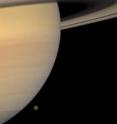 Titan, the largest of Saturn's moons, is about to slip behind the planet in this portrait captured by the Cassini spacecraft in 2008.