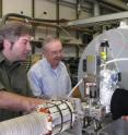 UCSD physicists James Danielson, Clifford Surko and Craig Schallhorn (left to right) inspect the apparatus they are using to develop the world's largest trap for low-energy positrons, planned to hold a trillion or more antiparticles.