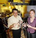 Julia Kubanek and Facundo Fernandez, both associate professors at the Georgia Institute of Technology, hold a molecular model of a potential antimalarial drug under study.