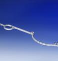 This is a surgical retractor with an integrated irrigation tube and connecting piece. It is additively manufactured from stainless steel.