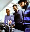 Research physicists Alberto Peruzzo (left), Jeremy O'Brien and Alberto Politi in front of the optical table.