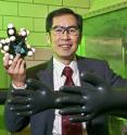 L. Keith Woo's hunt for green catalysts has led him to experiment with iron porphyrins. Here he's holding a model of an iron porphyrin compound in his Iowa State University research lab.