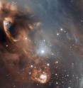 This very detailed false-colour image from ESO's Very Large Telescope shows the dramatic effects of very young stars on the dust and gas from which they were born in the star-forming region NGC 6729. The baby stars are invisible in this picture, being hidden behind dust clouds at the upper left of the picture, but material they are ejecting is crashing into the surroundings at speeds of that can be as high as one million kilometers per second. This picture was taken by the FORS1 instrument and records the scene in the light of glowing hydrogen and sulfur.