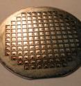 This is a fully functional solid-oxide fuel cell membrane wafer. The structured surface of each square chip lends stability to the incredibly thin film that is used for the electrochemical membrane.