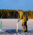 Sediment samples are collected from an ice-covered lake.