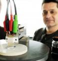 4-point conductivity measurement of the new transparent conducting film developed by Professors Cor Koning (left) and Paul van der Schoot (right). The black pot contains a dispersion of carbon nanotubes in water, and the white pot contains the conducting latex. 4-point conductivity measurement of the new transparent conducting film developed by Professors Cor Koning (left) and Paul van der Schoot (right). The black pot contains a dispersion of carbon nanotubes in water, and the white pot contains the conducting latex.