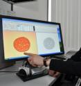 Mauro Tambasco, Ph.D., analyzes breast tissue samples on his computer.