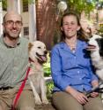 Researchers of a landmark UGA study regarding breed-specific causes of death in dogs sit with their own pets. Daniel Promislow (left) is flanked by Silver, a Weimaraner (bottom left) and Frisbee, a mixed breed (center). Dr. Kate Creevy (right) sits with her Border Collie, Makazi.