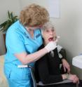 Rita Jablonski, assistant professor of nursing, Penn State, uses an actor to demonstrate Managing Oral Hygiene Using Threat Reduction, a technique she helped develop for dementia patients.