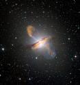 Merging X-ray data (blue) from NASA's Chandra X-ray Observatory with microwave (orange) and visible images reveals the jets and radio-emitting lobes emanating from Centaurus A's central black hole.