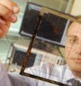 Georgia Tech School of Electrical and Computer Engineering (ECE) professor Manos Tentzeris displays an inkjet-printed rectifying antenna, or rectenna, used to convert microwave energy to DC power. This rectenna grid was printed on flexible Kapton material and is expected to operate with frequencies as high as 10 gigahertz when complete.
