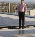 Jan Kleissl, a professor of environmental engineering at the UC San Diego Jacobs School of Engineering, poses with the solar panels his team studied.