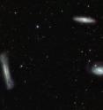 Triplet of bright galaxies in the constellation of Leo (the Lion), together with a multitude of fainter objects: distant background galaxies and much closer Milky Way stars. The image hints at the power of the VST and OmegaCAM for surveying the extragalactic Universe and for mapping the low brightness objects of the galactic halo. This image is a composite created by combining exposures taken through three different filters. Light that passed through a near-infrared filter was colored red, light in the red part of the spectrum is colored green, and green light is colored magenta.