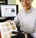 While wearing a glove with a vibrating fingertip designed to improve his sense of touch, Georgia Tech mechanical engineering assistant professor Jun Ueda performs a texture discrimination test.  Preliminary test results show that healthy individuals performed statistically better on this type of task when mechanical vibration was applied by the glove.